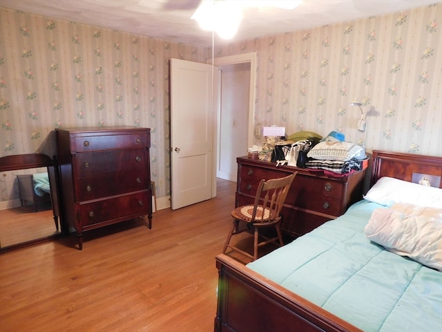 bedroom with light hardwood / wood-style flooring and ceiling fan