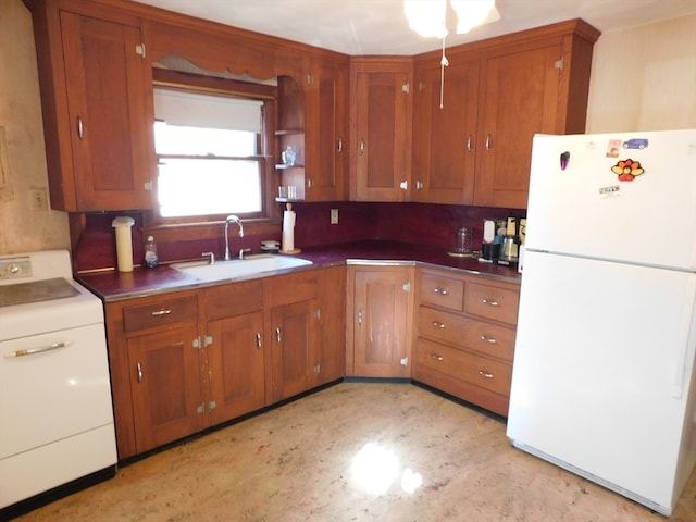 kitchen with washer / dryer, white refrigerator, tasteful backsplash, and sink