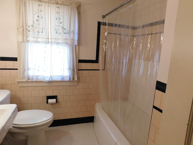 bathroom with tile patterned floors, toilet, shower / bathtub combination with curtain, and tile walls