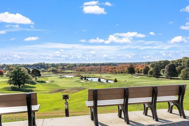 view of property's community featuring a patio area and a lawn