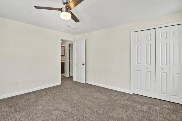 unfurnished bedroom with dark colored carpet, a closet, a ceiling fan, and baseboards