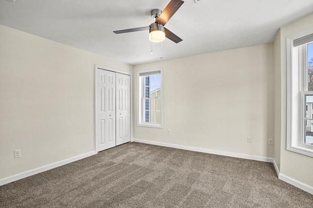 unfurnished bedroom with a ceiling fan, carpet, a closet, and baseboards