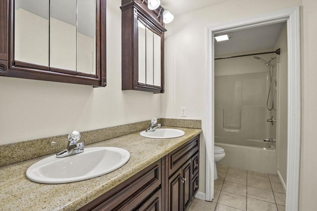 full bath with washtub / shower combination, tile patterned flooring, a sink, and toilet