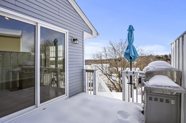 view of snow covered back of property