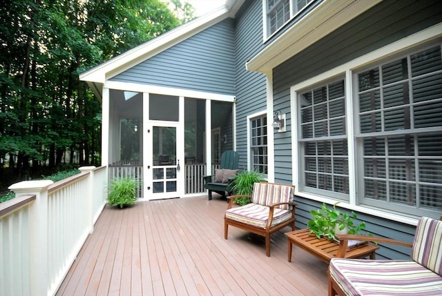 wooden deck with a sunroom