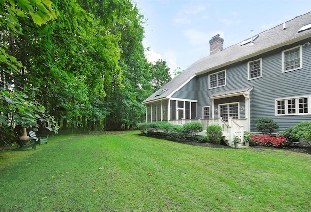 view of yard with a sunroom