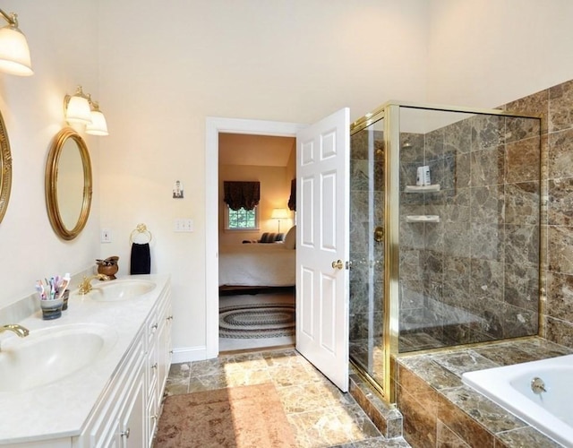 full bath featuring a sink, a stall shower, ensuite bath, and tiled bath