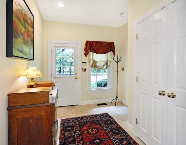 entryway with light tile patterned floors, visible vents, recessed lighting, and baseboards