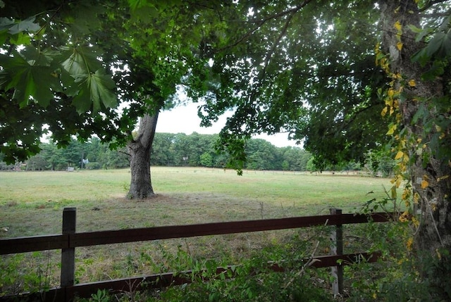 view of yard featuring a rural view and fence