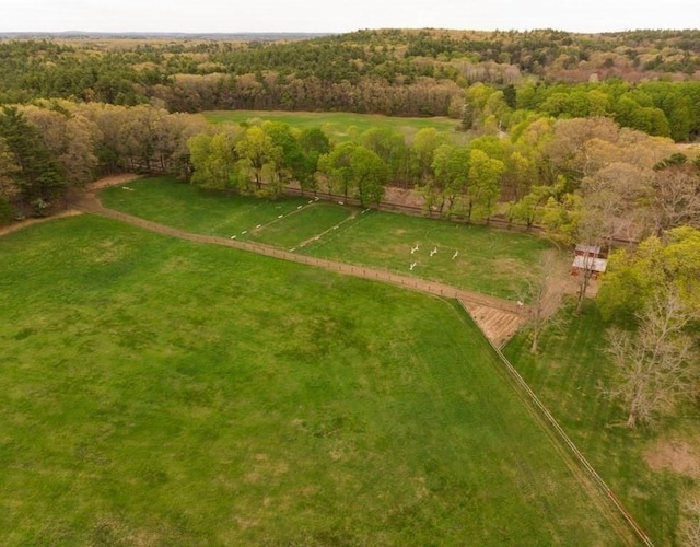 drone / aerial view featuring a wooded view