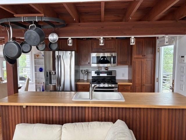 7 Cove St, Mattapoisett, MA 02739 - kitchen featuring stainless steel appliances, light countertops, and a wooden ceiling with exposed beams