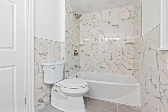 bathroom featuring toilet, shower / bath combination, and tile walls