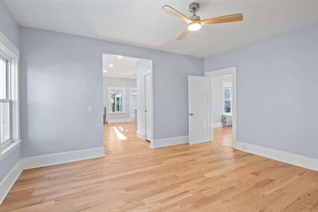 empty room featuring light hardwood / wood-style flooring and ceiling fan