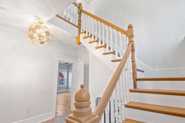 stairway featuring an inviting chandelier