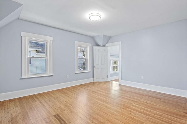 empty room featuring lofted ceiling and light wood-type flooring