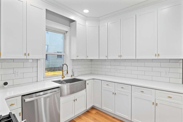 kitchen featuring white cabinetry, sink, and stainless steel dishwasher