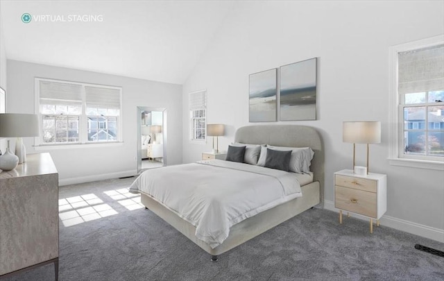 carpeted bedroom featuring baseboards and vaulted ceiling