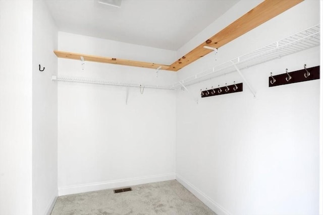 walk in closet featuring carpet flooring and visible vents