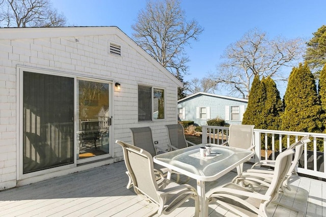 wooden deck featuring outdoor dining area