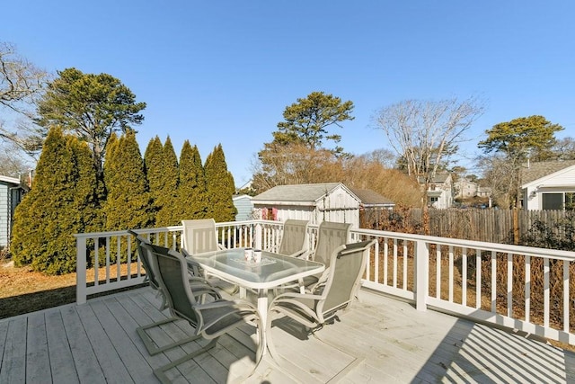 wooden deck with outdoor dining area and fence