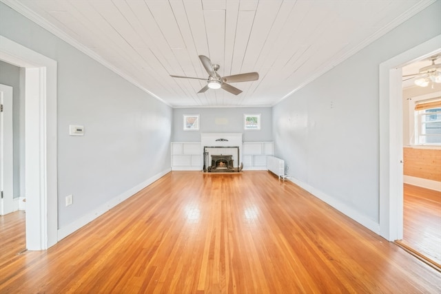 unfurnished living room with ceiling fan, light wood-type flooring, radiator heating unit, and crown molding