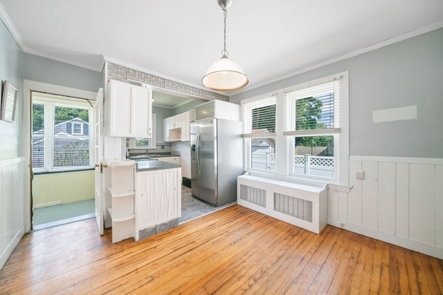 kitchen featuring light hardwood / wood-style flooring, stainless steel fridge with ice dispenser, and plenty of natural light