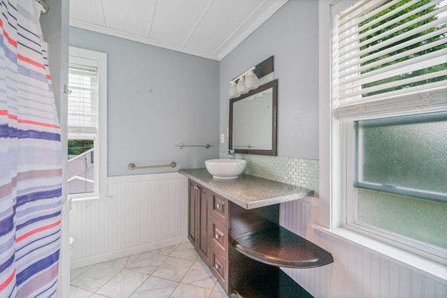 bathroom with a wealth of natural light, decorative backsplash, tile patterned flooring, and vanity