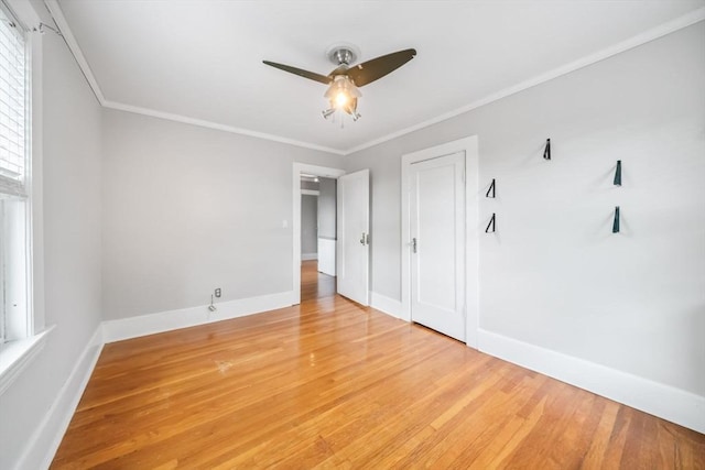 unfurnished bedroom featuring crown molding, ceiling fan, and wood-type flooring