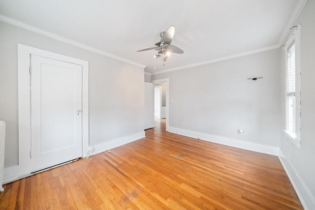 empty room with crown molding, ceiling fan, and light hardwood / wood-style flooring