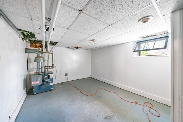 basement featuring a paneled ceiling