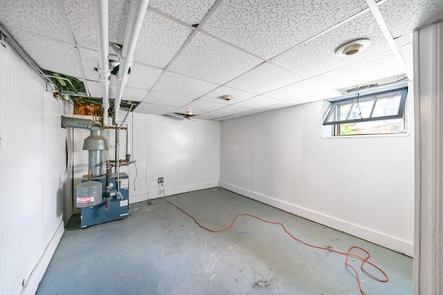 basement with a paneled ceiling