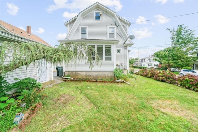 back of property featuring a lawn