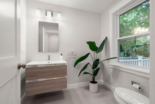 22 Carter St, Newton, MA 02460 - bathroom with vanity, toilet, tile patterned flooring, and baseboards
