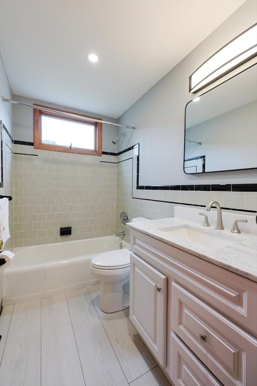 47 Forest St, Franklin, MA 02038 - bathroom with  shower combination, toilet, tile walls, vanity, and wood finished floors
