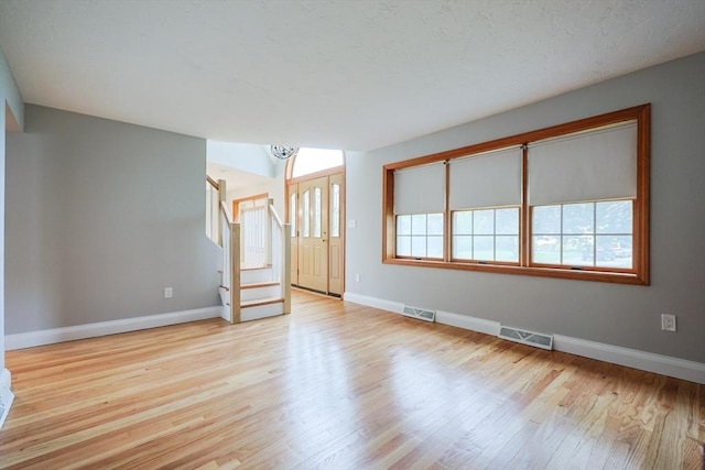 47 Forest St, Franklin, MA 02038 - spare room featuring baseboards, stairs, and wood finished floors