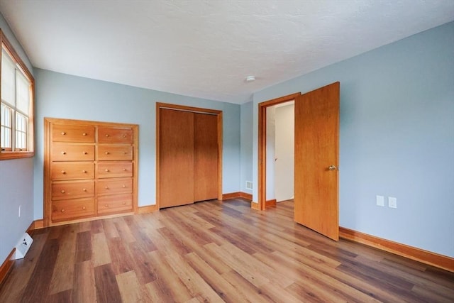 47 Forest St, Franklin, MA 02038 - unfurnished bedroom with wood finished floors, baseboards, and a closet