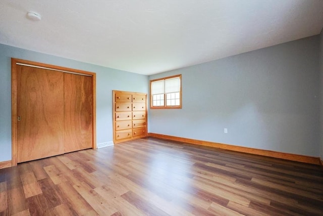 47 Forest St, Franklin, MA 02038 - unfurnished bedroom featuring wood finished floors, baseboards, and a closet
