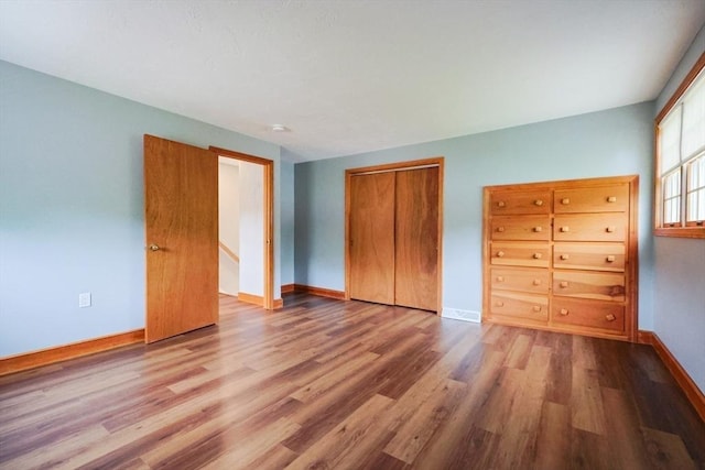 47 Forest St, Franklin, MA 02038 - unfurnished bedroom with wood finished floors, baseboards, and a closet