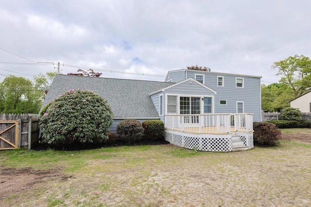 47 Forest St, Franklin, MA 02038 - rear view of house with fence, a wooden deck, and roof with shingles