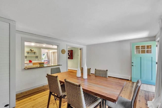 274 Morton Rd, Chatham, MA 02659 - dining room featuring light wood-type flooring, baseboard heating, and baseboards