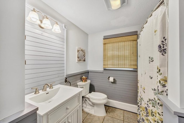 274 Morton Rd, Chatham, MA 02659 - bathroom with a baseboard heating unit, toilet, vanity, tile patterned floors, and wainscoting