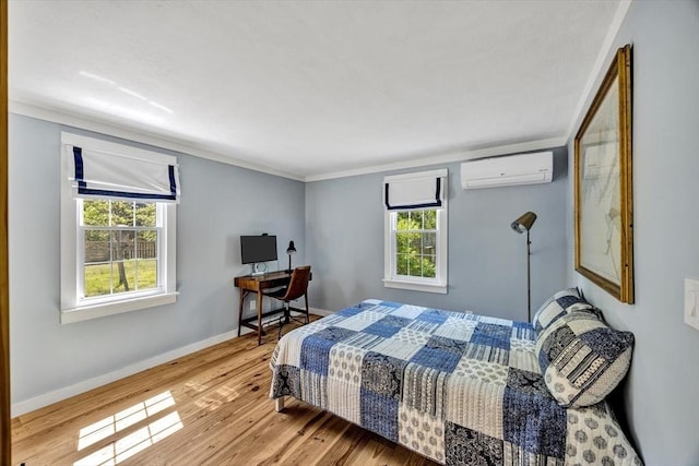 274 Morton Rd, Chatham, MA 02659 - bedroom featuring a wall mounted AC, wood finished floors, ornamental molding, and baseboards