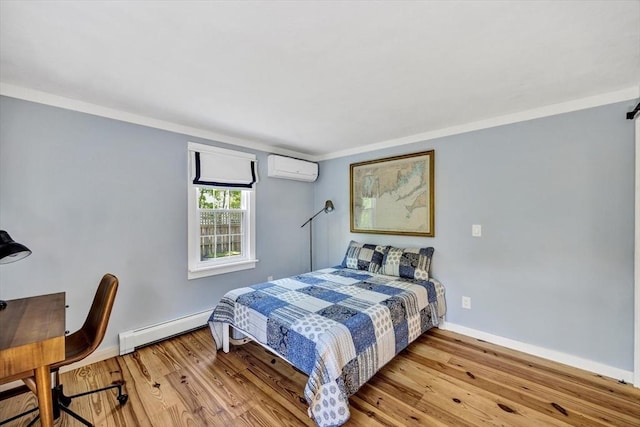 274 Morton Rd, Chatham, MA 02659 - bedroom featuring a wall mounted air conditioner, a baseboard heating unit, wood finished floors, and baseboards
