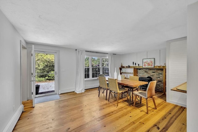 274 Morton Rd, Chatham, MA 02659 - dining room with a baseboard radiator, light wood finished floors, healthy amount of natural light, and baseboards
