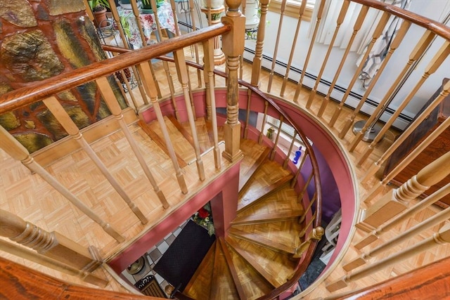 staircase featuring parquet floors