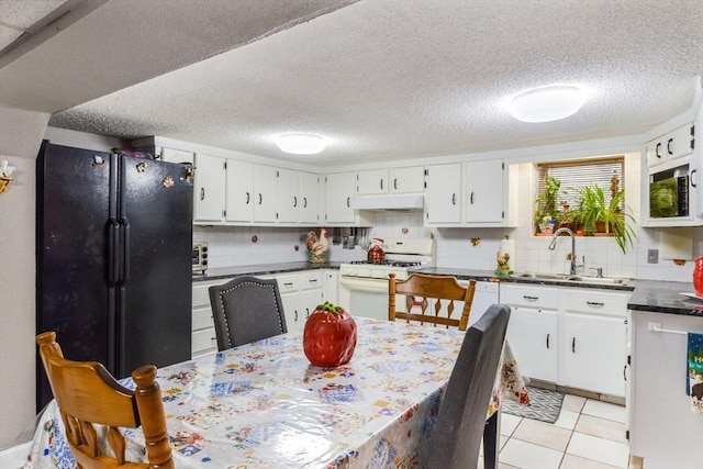 kitchen with white cabinetry, sink, backsplash, and black appliances