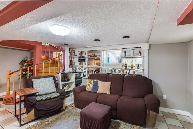 living room with light tile patterned flooring and a textured ceiling