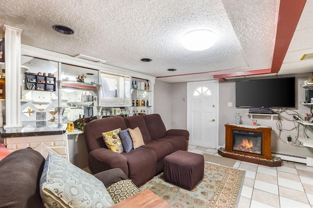 tiled living room with baseboard heating and a textured ceiling