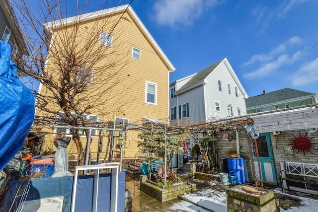 back of property with a pergola