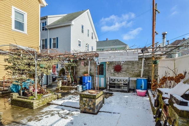 snow covered patio with a pergola